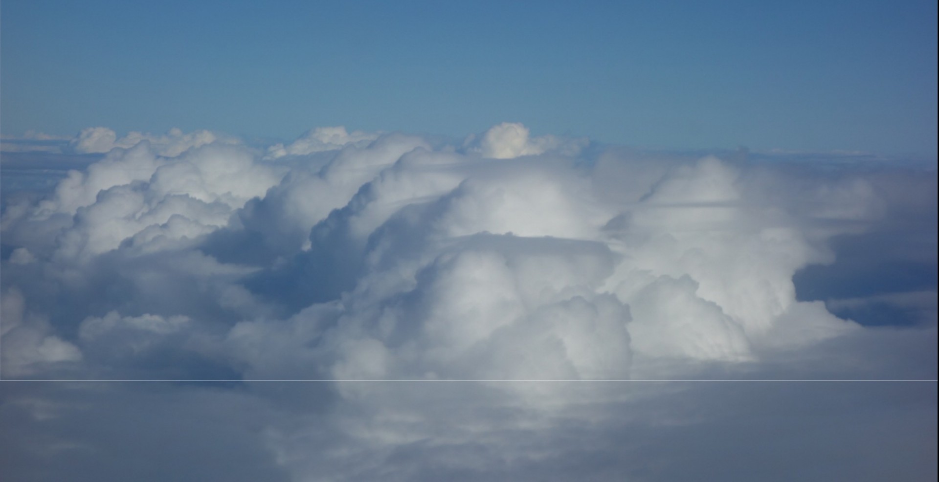 Photo of clouds over the Atlantic Ocean seen from a research aircraft during the ATOMIC field campaign in 2020